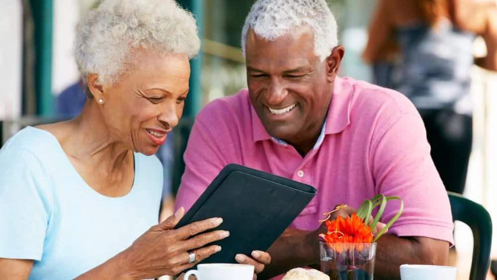 Elderly couple looking at an iPad