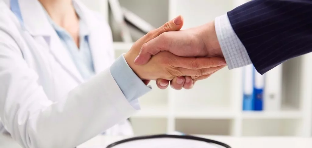 Doctor and patient shaking hands