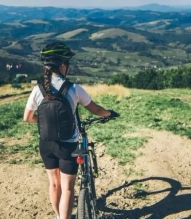 Woman with a mountain bike enjoying the view