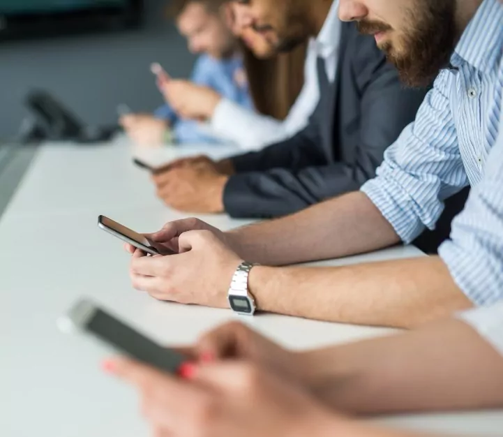 Row of people using smart phones