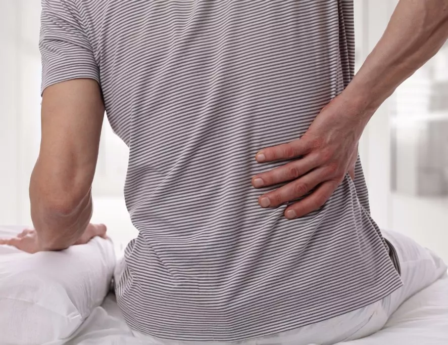 Man gripping his lower back
