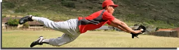Baseball player diving to catch a ball