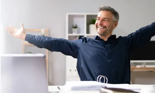 Photo: Man stretching at desk