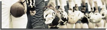 Football players with helmets off standing in a line