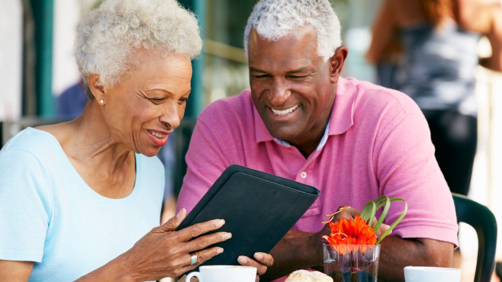 Elderly couple looking at an iPad