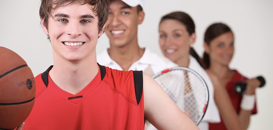 4 people dressed to play various sports