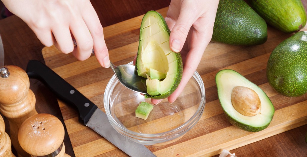 Person cutting up an avocado