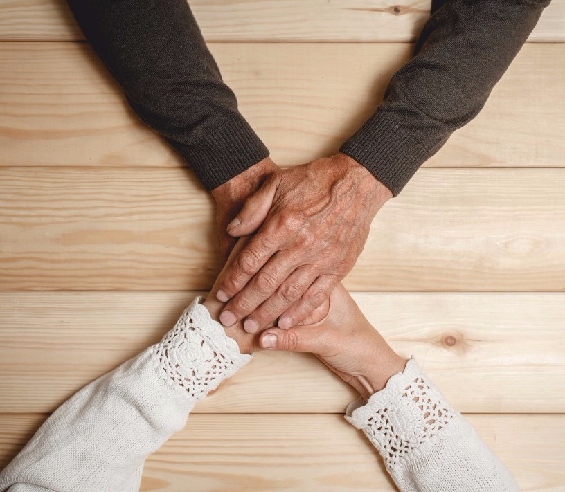 Two people holding hands