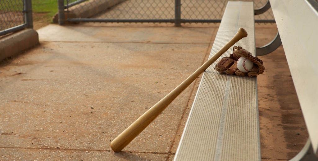 baseball bat and glove at a baseball field