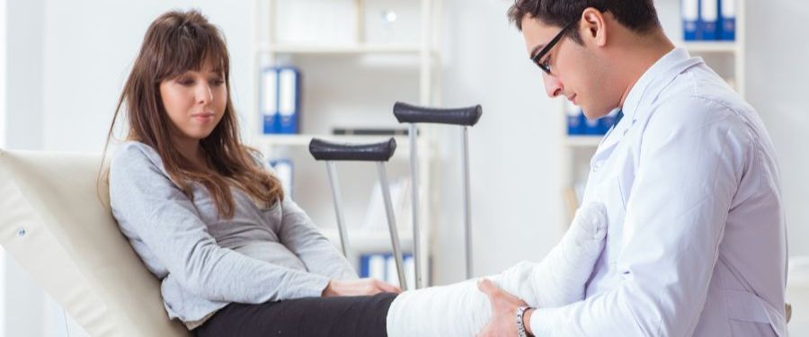 Doctor holding a patient's leg in a cast