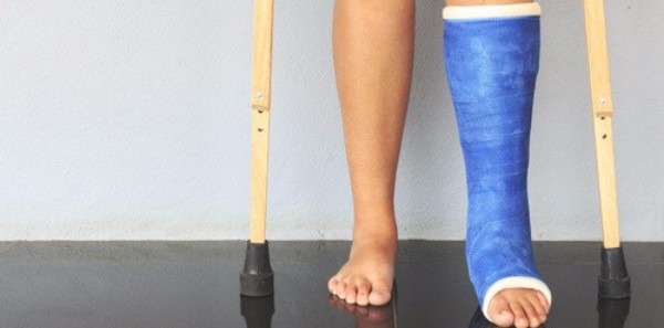 person with a blue cast on their leg and crutches