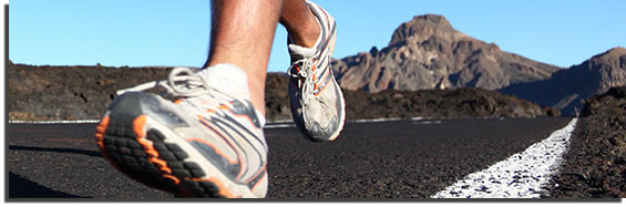 close up of shoes running on asphalt