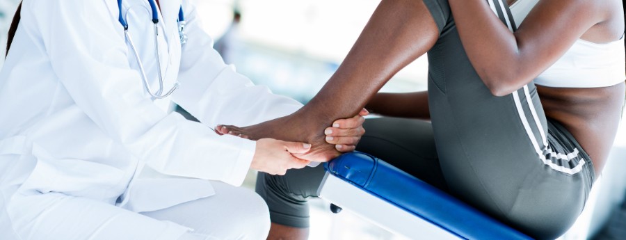 Doctor evaluating a patient's ankle